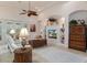 Bright living room with comfy seating, built-in shelving, and a large TV at 9312 Gentle Ben Ct, Weeki Wachee, FL 34613