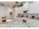 Spacious kitchen with granite countertops and white cabinets at 9312 Gentle Ben Ct, Weeki Wachee, FL 34613