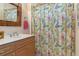 Guest bathroom with shower/tub combo and wood vanity at 9312 Gentle Ben Ct, Weeki Wachee, FL 34613