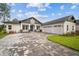 New construction home with three-car garage and paver driveway at 19395 Sheltered Hill Dr, Brooksville, FL 34601