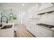 White kitchen with stainless steel appliances and expansive countertops at 19395 Sheltered Hill Dr, Brooksville, FL 34601