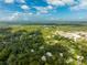 An aerial view of a neighborhood with houses and lush greenery at 321 S Brooksville Ave, Brooksville, FL 34601