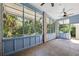 Spacious screened porch with light blue walls and ceiling fan at 321 S Brooksville Ave, Brooksville, FL 34601
