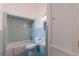 Bathroom with teal tile, bathtub, and toilet at 321 S Brooksville Ave, Brooksville, FL 34601