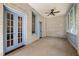 Screened porch with brick walls, light blue doors, and ceiling fan at 321 S Brooksville Ave, Brooksville, FL 34601
