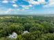 An aerial shot showcasing a home surrounded by trees and greenery at 321 S Brooksville Ave, Brooksville, FL 34601