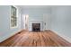 Hardwood floor bedroom with fireplace and light blue walls at 321 S Brooksville Ave, Brooksville, FL 34601