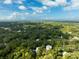 Aerial view showcasing a home amongst green trees and landscape at 321 S Brooksville Ave, Brooksville, FL 34601