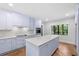 Spacious kitchen with light purple cabinets, quartz countertops, and herringbone floors at 321 S Brooksville Ave, Brooksville, FL 34601