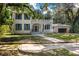 Two story brick home with blue shutters and a wrap around porch at 321 S Brooksville Ave, Brooksville, FL 34601