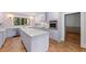 Updated kitchen with lavender cabinets, quartz countertops, and stainless steel appliances at 321 S Brooksville Ave, Brooksville, FL 34601