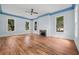 Hardwood floors, fireplace, and ceiling fan at 321 S Brooksville Ave, Brooksville, FL 34601