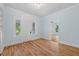 Home office with built-in shelving, hardwood floors, and light blue walls at 321 S Brooksville Ave, Brooksville, FL 34601