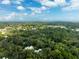 Aerial view of a house nestled in a lush, green landscape at 321 S Brooksville Ave, Brooksville, FL 34601