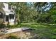 Large backyard with lush green grass and mature trees at 321 S Brooksville Ave, Brooksville, FL 34601