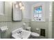 Simple bathroom with light green tile and pedestal sink at 321 S Brooksville Ave, Brooksville, FL 34601