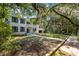 Two story brick home with blue shutters and a wrap around porch at 321 S Brooksville Ave, Brooksville, FL 34601