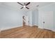 Bedroom with hardwood floors, ceiling fan and view of staircase at 321 S Brooksville Ave, Brooksville, FL 34601