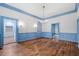 Spacious dining room with hardwood floors and blue wainscoting at 321 S Brooksville Ave, Brooksville, FL 34601
