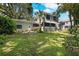 House's backyard with lush lawn and mature trees at 321 S Brooksville Ave, Brooksville, FL 34601