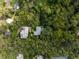 Aerial view of two houses on a tree-lined property at 321 S Brooksville Ave, Brooksville, FL 34601