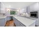 Modern kitchen with lavender cabinets, quartz countertops, and an island at 321 S Brooksville Ave, Brooksville, FL 34601