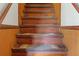 View of vintage wooden staircase with worn carpet runners at 14335 Snow Memorial Hwy, Brooksville, FL 34601