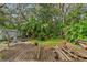 Large backyard with shed, grill, and wooden deck at 14335 Snow Memorial Hwy, Brooksville, FL 34601