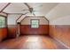 Attic bedroom with wood floors, wood paneling and window at 14335 Snow Memorial Hwy, Brooksville, FL 34601