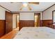 Bedroom with wood flooring, ceiling fan and access to bathroom at 14335 Snow Memorial Hwy, Brooksville, FL 34601