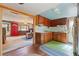 Small kitchen with wood cabinets and green flooring at 14335 Snow Memorial Hwy, Brooksville, FL 34601