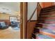 View of wooden staircase leading to the upper level and living room at 14335 Snow Memorial Hwy, Brooksville, FL 34601
