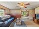 Living room features a blue sofa and wooden coffee table at 14335 Snow Memorial Hwy, Brooksville, FL 34601