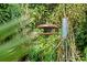 Rustic bird feeder hanging in a tree-filled backyard at 14335 Snow Memorial Hwy, Brooksville, FL 34601