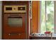Close-up of a vintage, brown built-in oven at 14335 Snow Memorial Hwy, Brooksville, FL 34601
