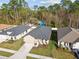 Aerial view of the home showcasing its landscaped yard and proximity to other homes in the neighborhood at 11512 Weaver Hollow Rd, New Port Richey, FL 34654