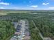 Community aerial view showcasing homes, lush green spaces, and a serene pond at 11512 Weaver Hollow Rd, New Port Richey, FL 34654
