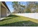 Well-maintained backyard with green grass and a white vinyl fence at 11512 Weaver Hollow Rd, New Port Richey, FL 34654