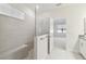 Modern bathroom features tiled shower with glass partition and built-in bench at 11512 Weaver Hollow Rd, New Port Richey, FL 34654
