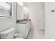 Bright bathroom with double vanity, modern fixtures, tile floor, and toilet at 11512 Weaver Hollow Rd, New Port Richey, FL 34654