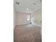 Neutral carpeted bedroom with a window, and a door to the right of the room at 11512 Weaver Hollow Rd, New Port Richey, FL 34654