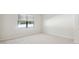 Bedroom with carpet, baseboard trim, one window with blinds, and neutral paint at 11512 Weaver Hollow Rd, New Port Richey, FL 34654