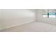 Bedroom with carpet, baseboard trim, one window with blinds, and neutral paint at 11512 Weaver Hollow Rd, New Port Richey, FL 34654