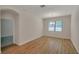 Bright dining room showcasing wood floors, a chandelier, and a window with blinds at 11512 Weaver Hollow Rd, New Port Richey, FL 34654