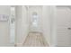 Bright entryway with wood-look floors, white walls, and a view into the main living areas at 11512 Weaver Hollow Rd, New Port Richey, FL 34654