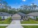 Charming single-story home with a two-car garage, a well-manicured lawn, and attractive landscaping at 11512 Weaver Hollow Rd, New Port Richey, FL 34654