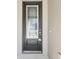 Close up of a traditional style front door with glass and dark hardware at 11512 Weaver Hollow Rd, New Port Richey, FL 34654