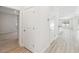 Hallway features wood floors, modern doorways and transitions to bedroom and kitchen at 11512 Weaver Hollow Rd, New Port Richey, FL 34654