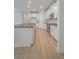 Contemporary kitchen featuring white cabinets, stainless steel appliances, and a center island with gray countertops at 11512 Weaver Hollow Rd, New Port Richey, FL 34654