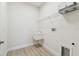 View of laundry room with sink, laminate floors, and wire rack shelving at 11512 Weaver Hollow Rd, New Port Richey, FL 34654